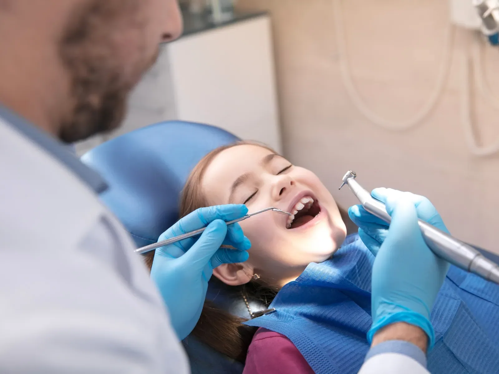 A child's teeth being examined during a dental cleaning